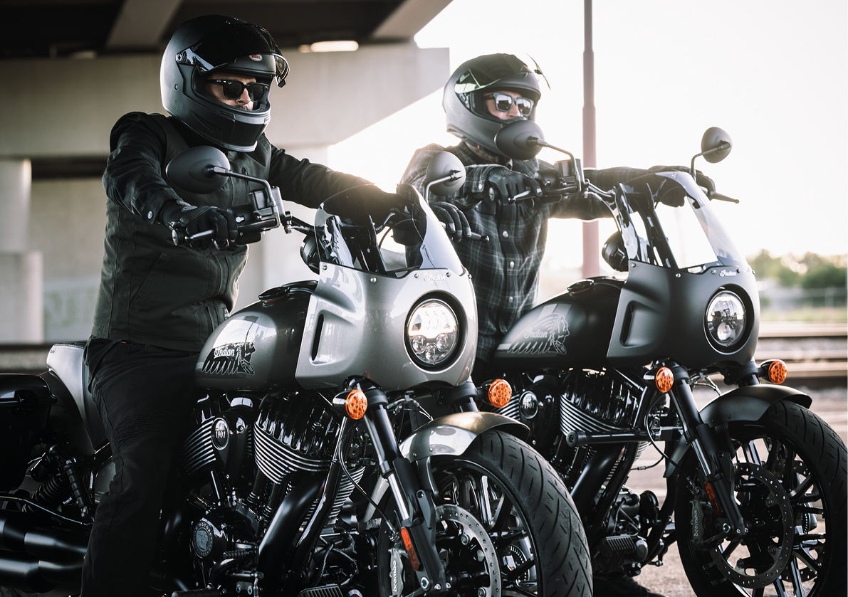 Two men wearing helmets and riding motorcycles. AI generated content